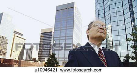 Stock Image - Businessman contemplates prospects. Fotosearch