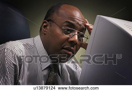 Picture - Businessman in front of computer screen. Fotosearch