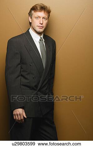 Businessman leaning on wall View Large Photo Image Stock Photo - Businessman leaning on wall. Fotosearch