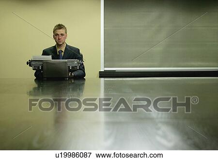 Businessman using typewriter View Large Photo Image Stock Photo - Businessman using typewriter. Fotosearch