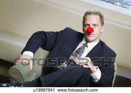 Businessman wearing red nose View Large Photo Image Stock Image - Businessman wearing red nose. Fotosearch