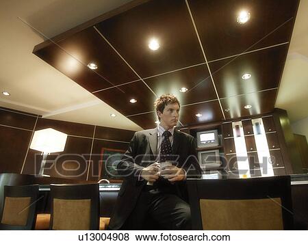 Businessman with a cup of coffee View Large Photo Image Stock Photo - Businessman with a cup of coffee. Fotosearch