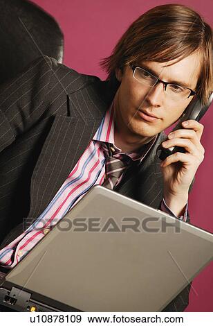 Businessman with phone and lap top View Large Photo Image Stock Photo - Businessman with phone and lap top. Fotosearch