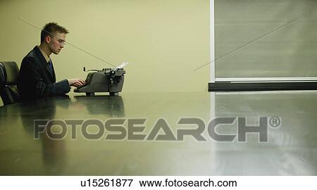 Stock Photo - Businessman working on typewriter. Fotosearch