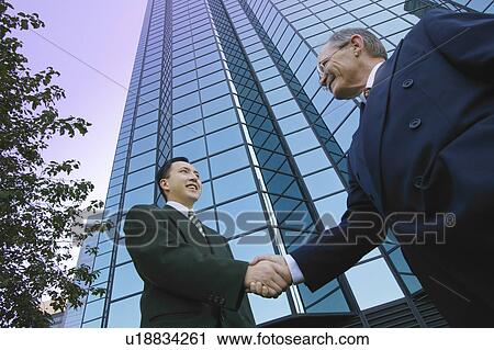 Businessmen shake hands View Large Photo Image Stock Image - Businessmen shake hands. Fotosearch