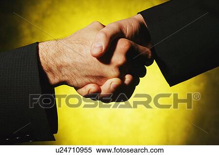 Stock Photography - Businessmen shake hands. Fotosearch