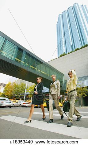 Stock Photo - Businesspeople crossing the street. Fotosearch