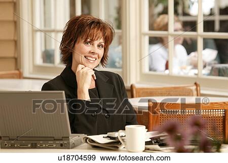 Stock Photo - Businesswoman in cafe. Fotosearch