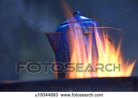 Stock Image - Camping kettle over fire. Fotosearch