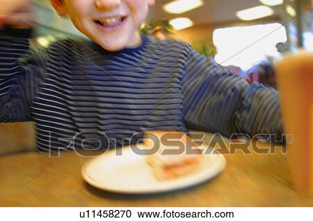 Stock Image - Child eats food. Fotosearch