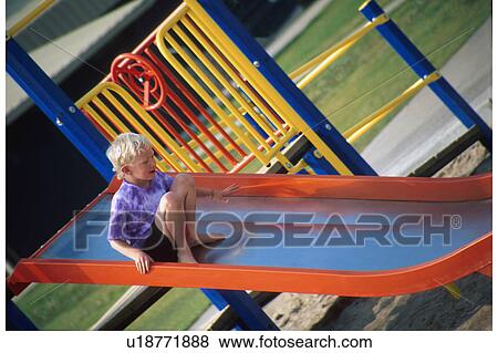 Child going down a slide View Large Photo Image Stock Photo - Child going down a slide. Fotosearch