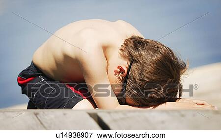Child lays on the beach View Large Photo Image Stock Photo - Child lays on the beach. Fotosearch