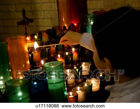 Stock Photo - Child lighting candle. Fotosearch