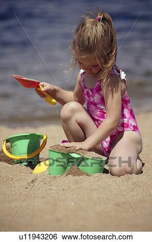 Child playing in the sand View Large Photo Image Stock Photograph - Child playing in the sand. Fotosearch