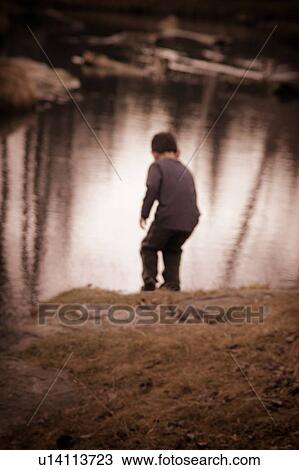 Child plays by water View Large Photo Image Stock Image - Child plays by water. Fotosearch