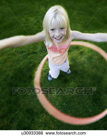 Stock Photo - Child plays with hoop. Fotosearch