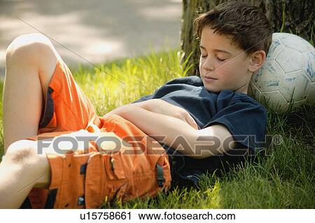 Child sleeps on soccer ball View Large Photo Image Stock Image - Child sleeps on soccer ball. Fotosearch