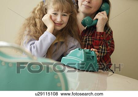 Stock Photo - Child waits while mother on phone. Fotosearch