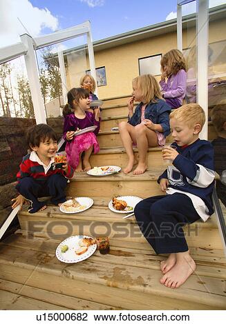 Stock Image - Children eating food. Fotosearch