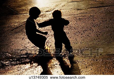 Children pushing in puddle View Large Photo Image Stock Photography - Children pushing in puddle. Fotosearch