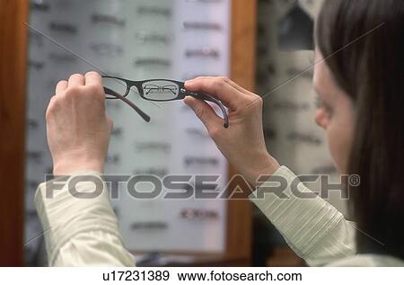 Stock Photo - Choosing some glasses. Fotosearch