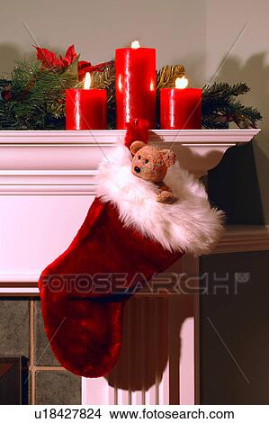 Picture - Christmas stocking hanging from fireplace mantle at Christmas. Fotosearch