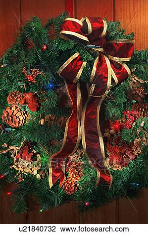 Stock Image - Christmas wreath with pinecones and bow. Fotosearch