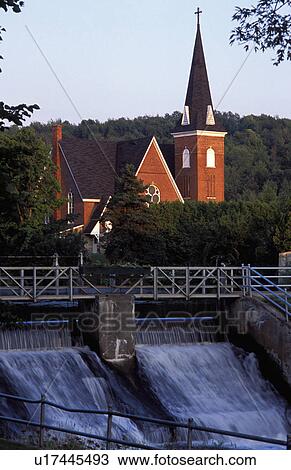 Stock Image - Church in background with dam. Fotosearch