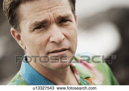 Stock Image - Close-up of man in bright shirt. Fotosearch