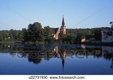 Countryside and church reflected in the lake View Large Photo Image Stock Image - Countryside and church reflected in the lake. Fotosearch