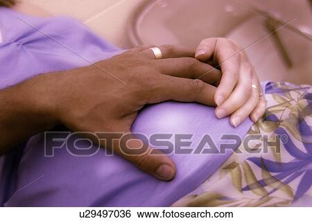 Couple expecting a child View Large Photo Image Stock Photograph - Couple expecting a child. Fotosearch