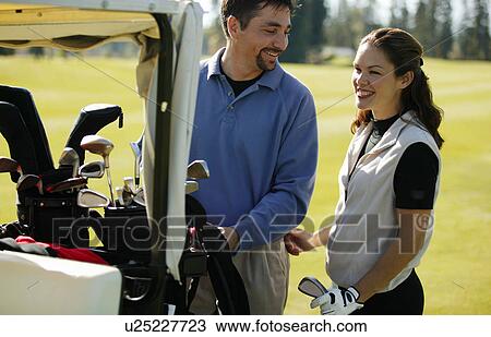 Stock Image - Couple goes golfing. Fotosearch