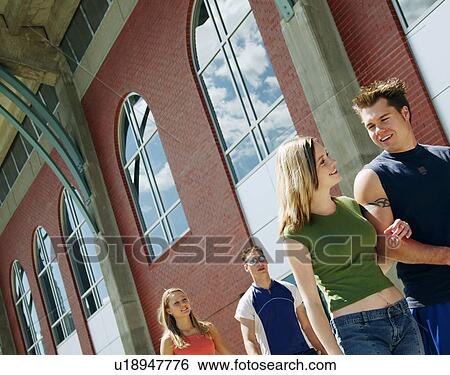 Stock Photograph - Couple hang out at school. Fotosearch