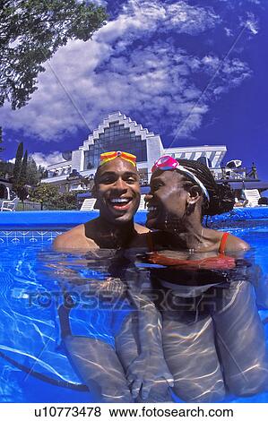 Couple having fun in swimming pool View Large Photo Image Stock Photo - Couple having fun in swimming pool. Fotosearch