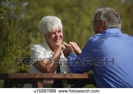 Stock Photo - Couple holds hands. Fotosearch