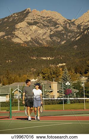 Stock Photograph - Couple in tennis courts. Fotosearch