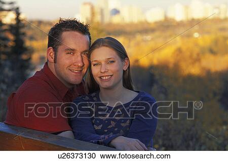 Stock Image - Couple on a park bench. Fotosearch