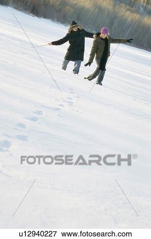 Couple play in the snow View Large Photo Image Stock Photo - Couple play in the snow. Fotosearch