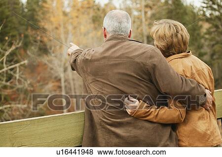 Couple pointing to trees View Large Photo Image Stock Photo - Couple pointing to trees. Fotosearch