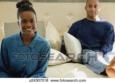Couple relaxes on bed View Large Photo Image Stock Photo - Couple relaxes on bed. Fotosearch