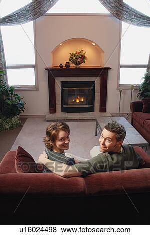 Stock Photo - Couple relaxing in front of fire. Fotosearch