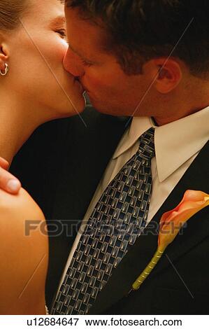 Couple shares a kiss View Large Photo Image Stock Photo - Couple shares a kiss. Fotosearch
