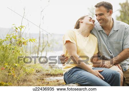 Couple sitting casually View Large Photo Image Stock Photography - Couple sitting casually. Fotosearch