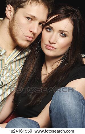 Stock Photo - Couple sitting close together. Fotosearch