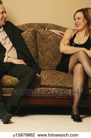 Stock Image - Couple talking on the sofa. Fotosearch