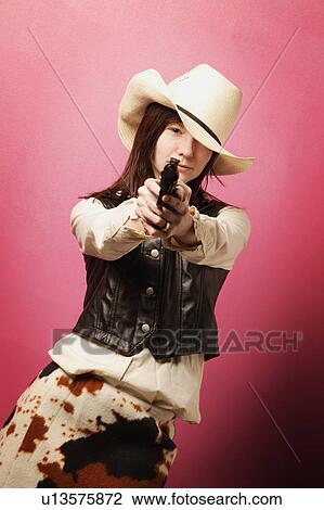 Stock Image - Cowgirl with gun. Fotosearch