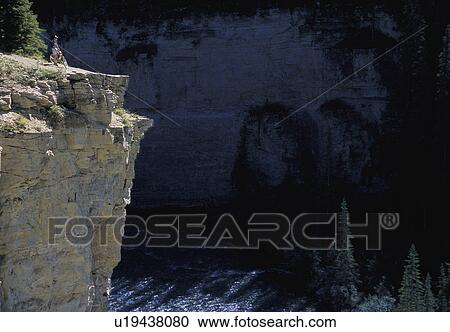 Cyclist looking over cliff View Large Photo Image Stock Image - Cyclist looking over cliff. Fotosearch