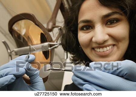 Stock Image - Dentist at work. Fotosearch