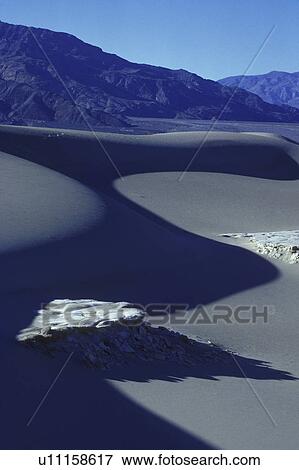 Stock Photo - Desert mountain with sand in foreground. Fotosearch