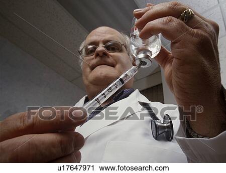 Doctor drawing injection View Large Photo Image Stock Image - Doctor drawing injection. Fotosearch